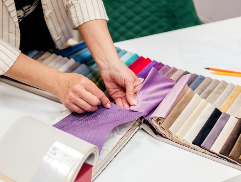 Female hands choosing fabric